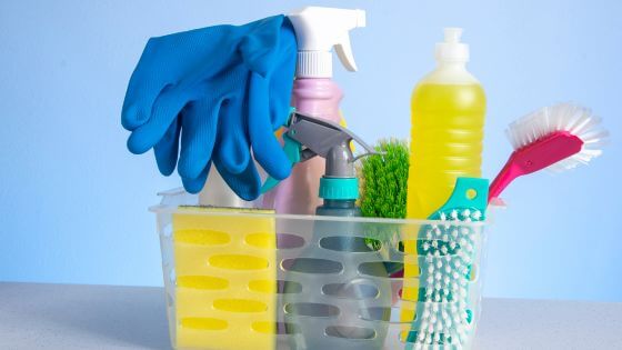 Cleaning supplies in clear plastic bucket