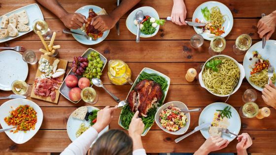 Rotisserie chicken, vegetables and fruit and noodle on a table