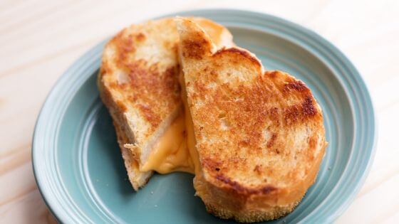 grilled cheese sandwich on a blue plate