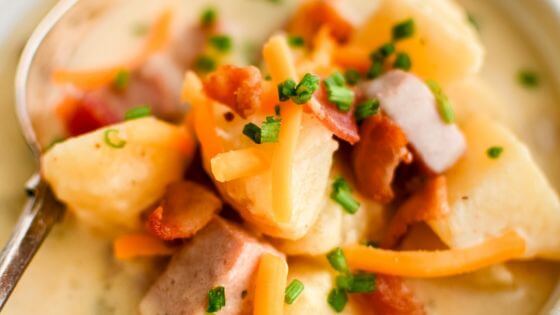 ham and potato soup in bowl with spoon