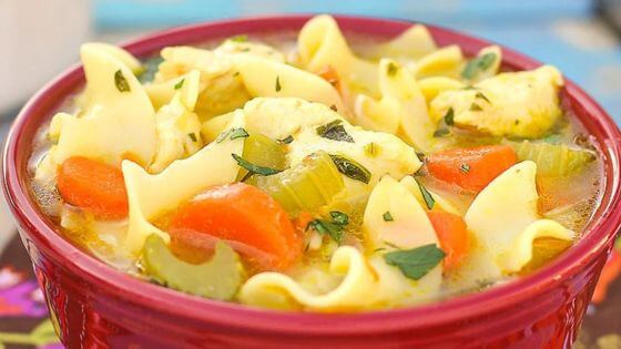 chicken noodle soup in red soup bowl