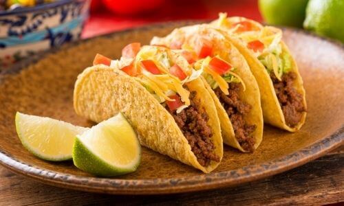 ground beef hard taco shells on brown platter