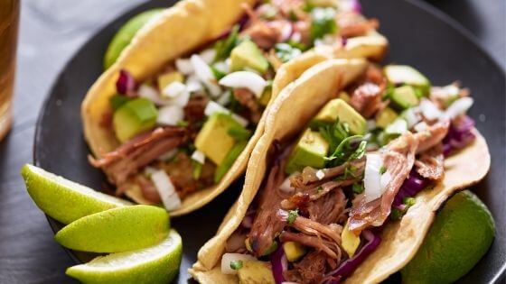 shredded pork in flour tortilla with lime and avocado