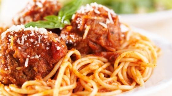 spaghetti with sauce and meatballs on white plate