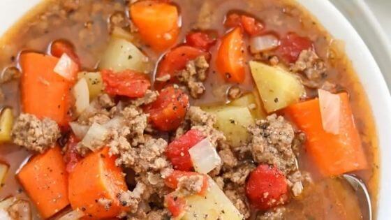 hamburger and vegetable soup in white bowl