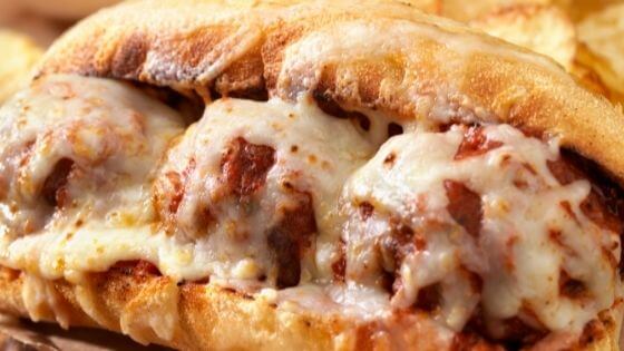 meatball sub on roll with mozzarella cheese melted on top