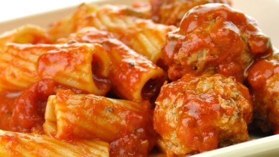 meatballs with sauce and rigatoni pasta on white plate