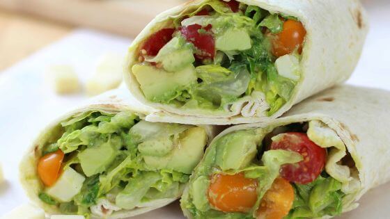 avocado tomato and vegetables in a wrap