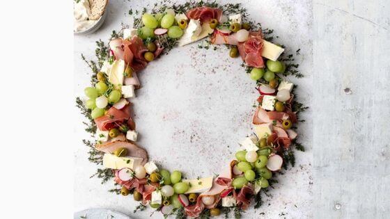 Charcuterie board with grapes, meats and cheeses in the shape of a wreath