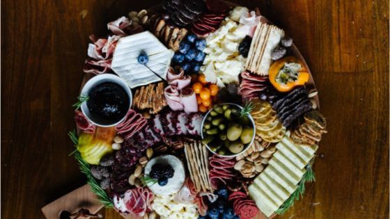 Thanksgiving charcuterie board with cheese, meat, crackers and fruits and vegetables