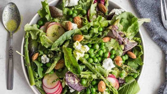 Salad with Peas and Asparagus on white plate