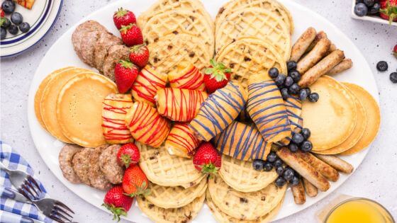 Charcuterie Board with waffles, sausage and strawberries