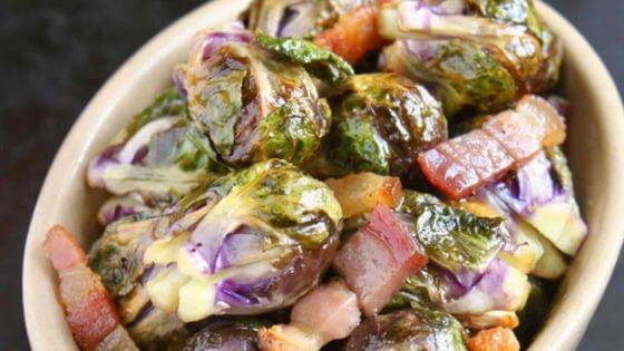 Brussels sprouts and pancetta in tan bowl