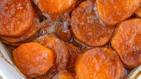 Candied sweet potatoes sliced in white baking dish