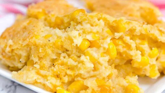 Corn casserole with corn and corn bread on white plate