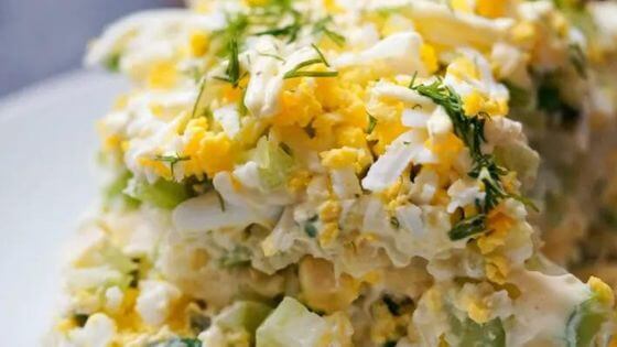 Layered potato and egg salad on white plate