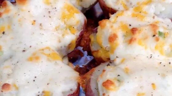 Twice baked potatoes in dish with cheese