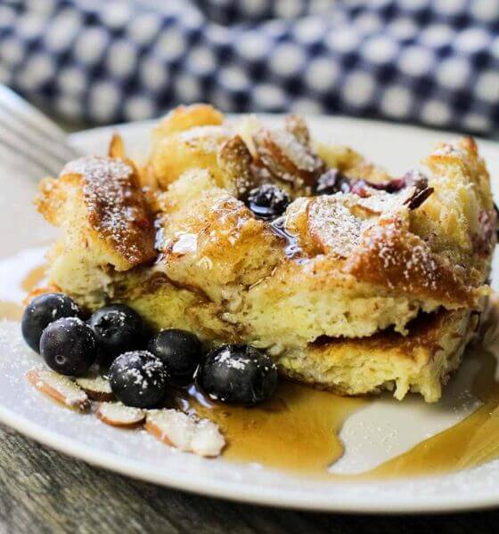 Blueberry French toast on white plate with syrup 