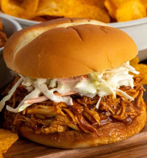Pulled Chicken in Hamburger Bun with Coleslaw on wooden board