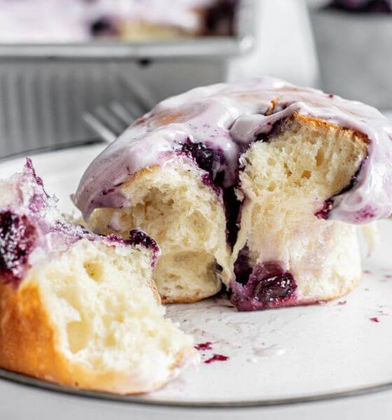 Blueberry cinnamon roll on white plate