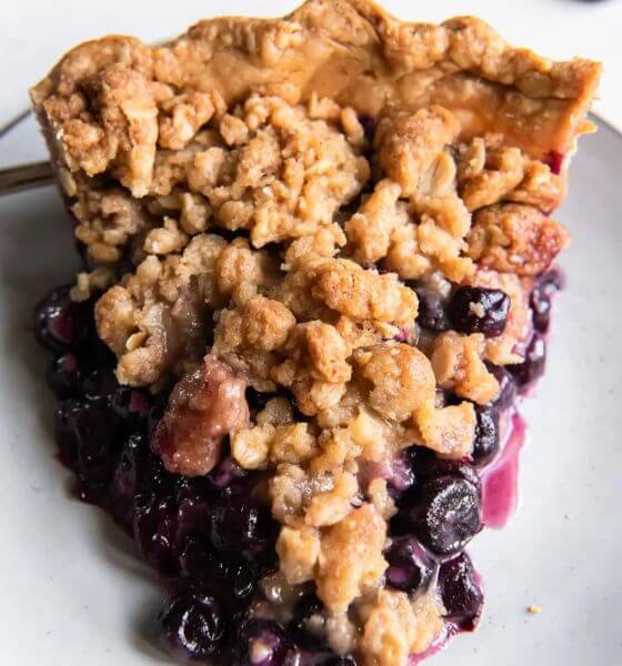 Blueberry crumble pie on white plate