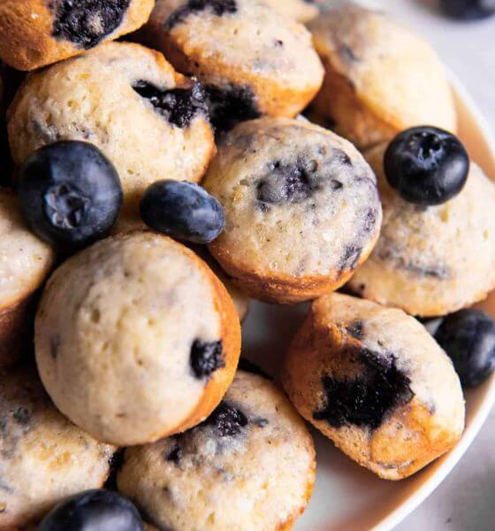 mini blueberry muffins on white platter