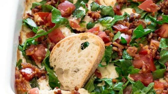 BLT dip in white baking dish with crusty bread on top