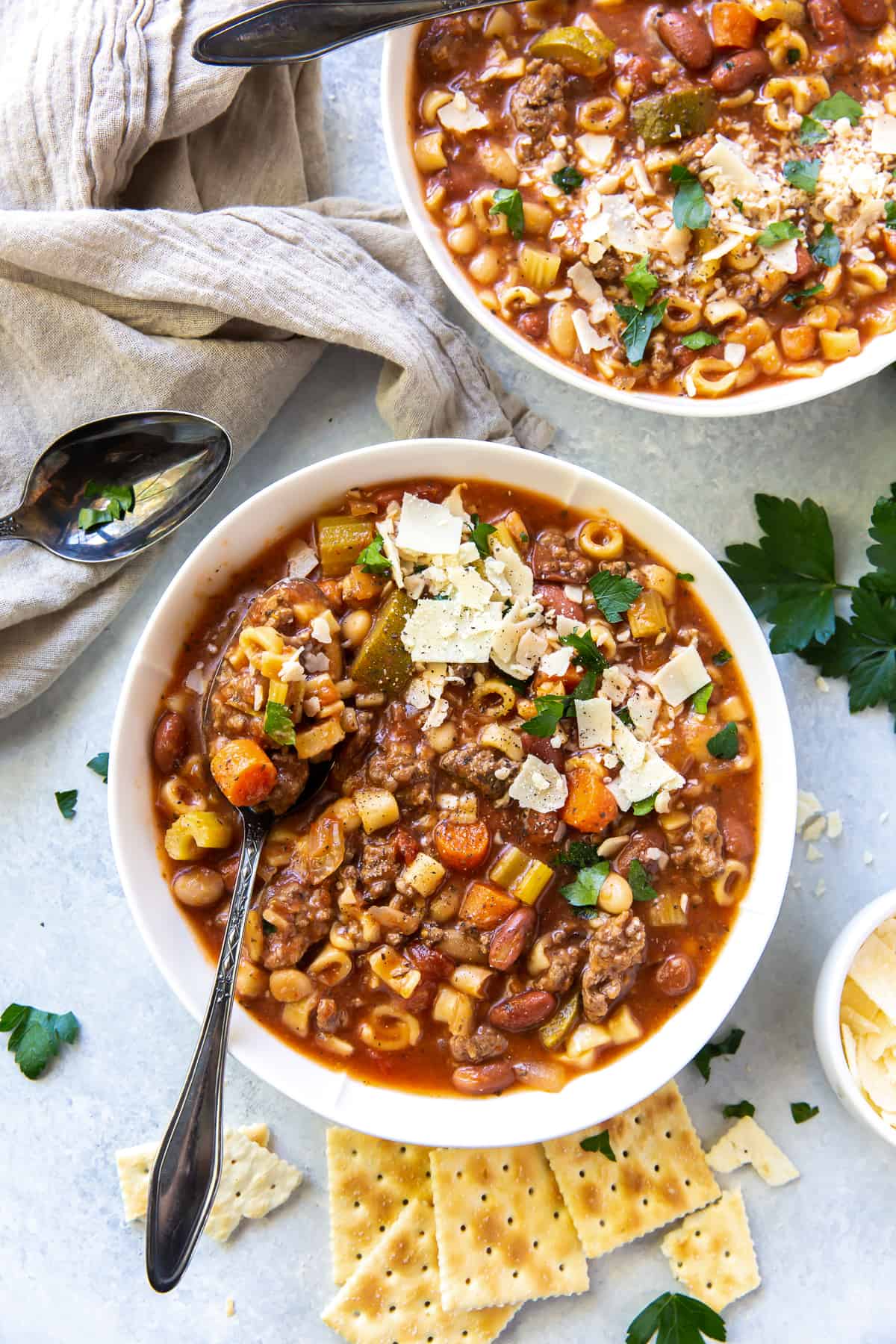 Minestrone in white bowl with spoon