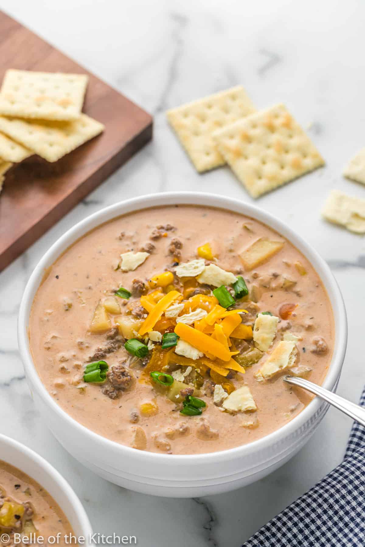 Cheeseburger soup in white bowl