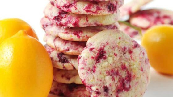 Stack of lemon raspberry cookies with lemons next to them