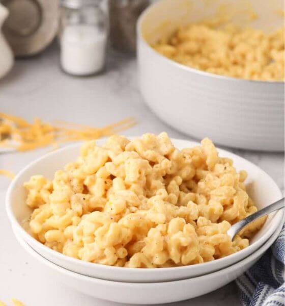 Macaroni and Cheese in a white bowl with spoon