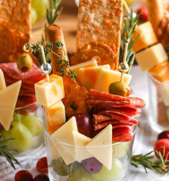 Charcuterie appetizer cups with pepperoni, cheese, olives and crackers.