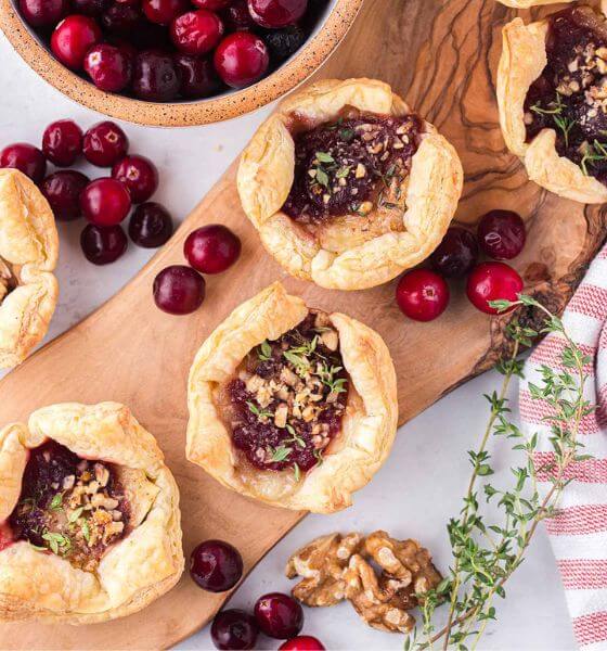 cranberry brie bites on wood board