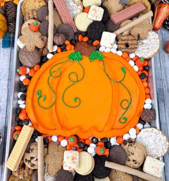 Pumpkin shaped dip with various types of cookies for dipping.