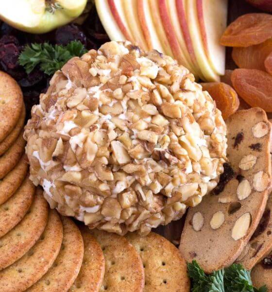 Cheese ball with crackers and apples on the side