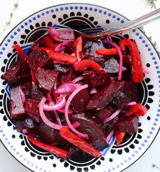 Pickled beets on white and blue plate