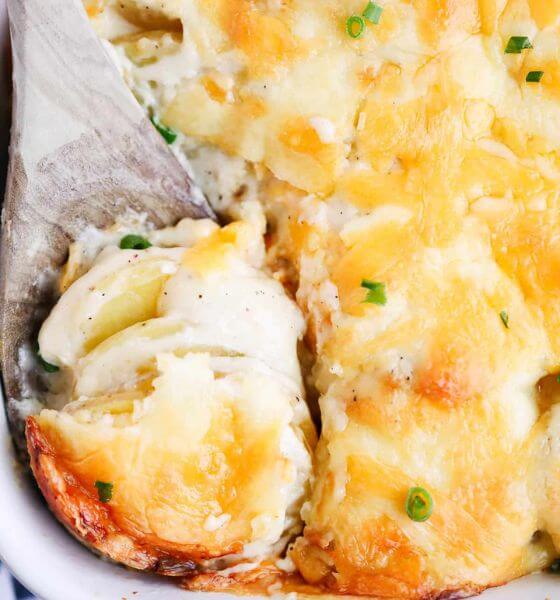 Scalloped potatoes in white baking dish