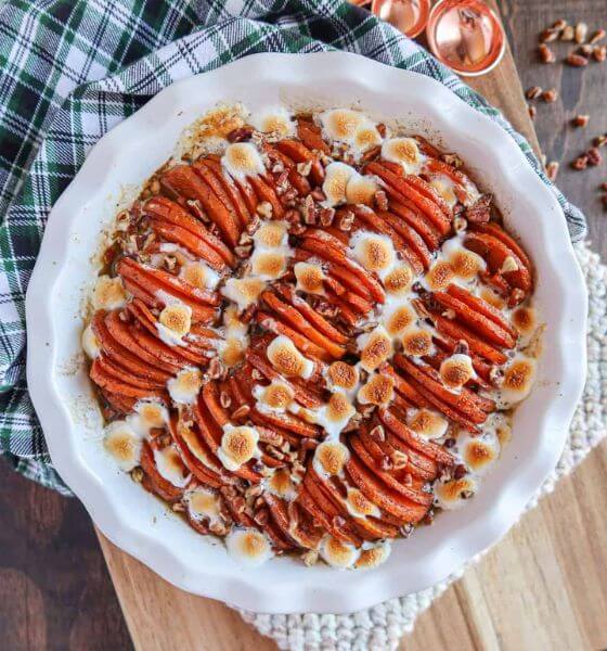 Scalloped sweet potatoes in white baking dish