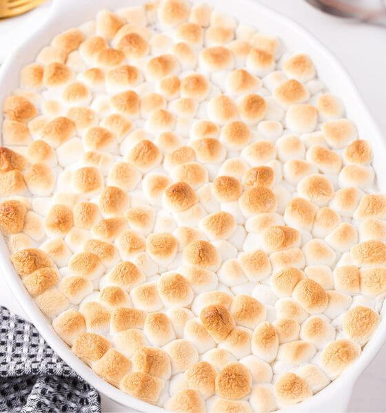 Sweet potato casserole with marshmallows in white baking dish