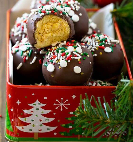 Cake truffles in red Christmas tin with sprinkles on top