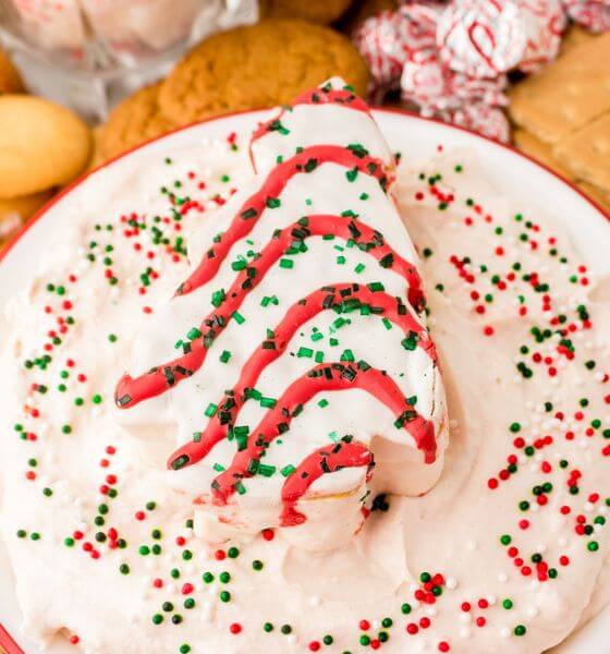 Christmas tree cake dip in bowl with red, white and green sprinkles on top