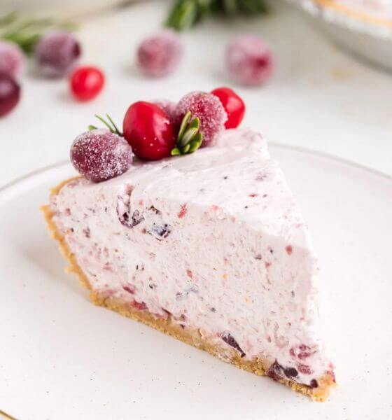 Cranberry pie on white plate with cranberries on top