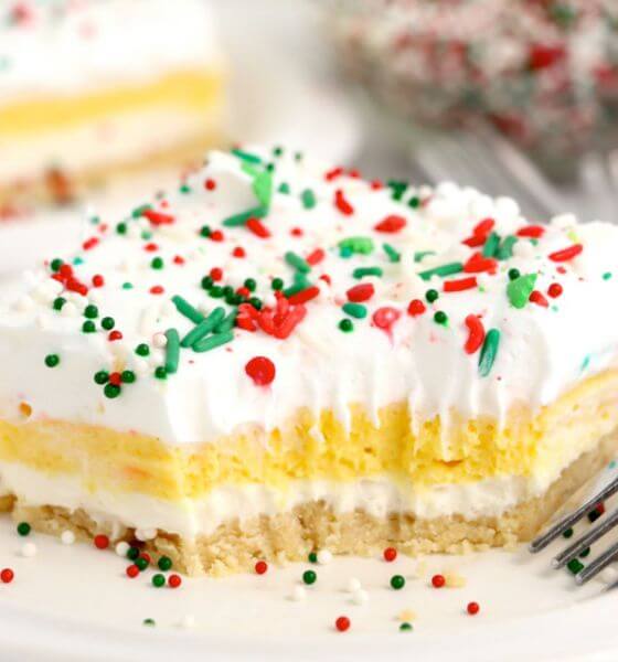 Eggnog pudding dessert with red, green and white sprinkles on a white plate