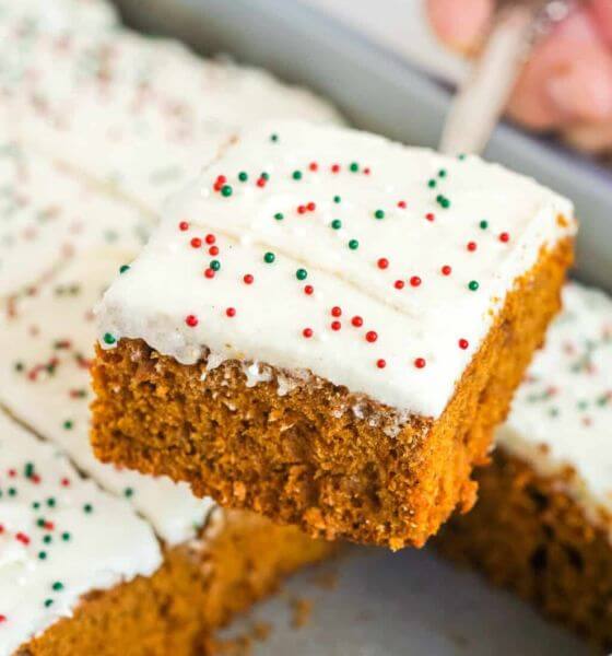 Holiday gingerbread sheet cake with white frosting and red, white and green sprinkles