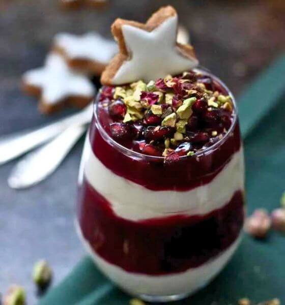 Holiday parfait in a glass dish with a white cookie star on top