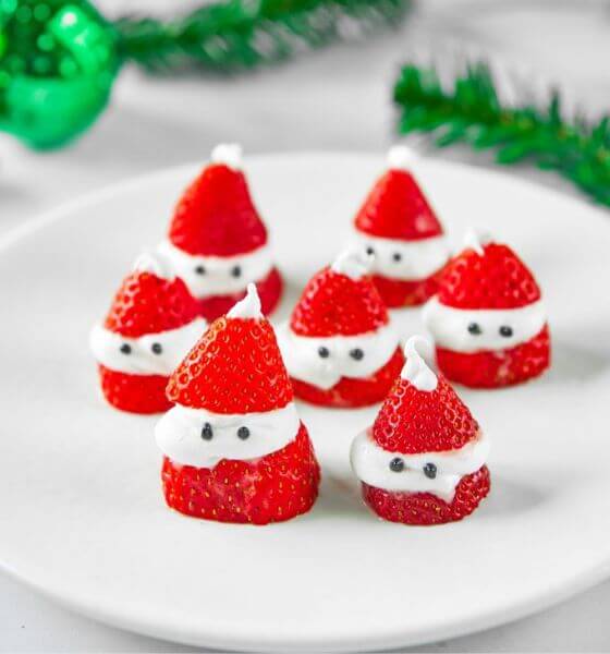Strawberries and cream Santa hats on a white plate