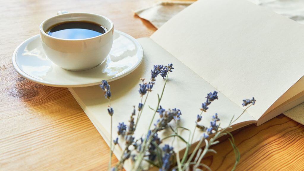 Notebook with coffee in cup and lavender