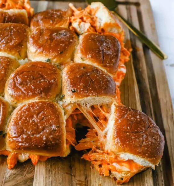 Buffalo chicken sliders on wooden board