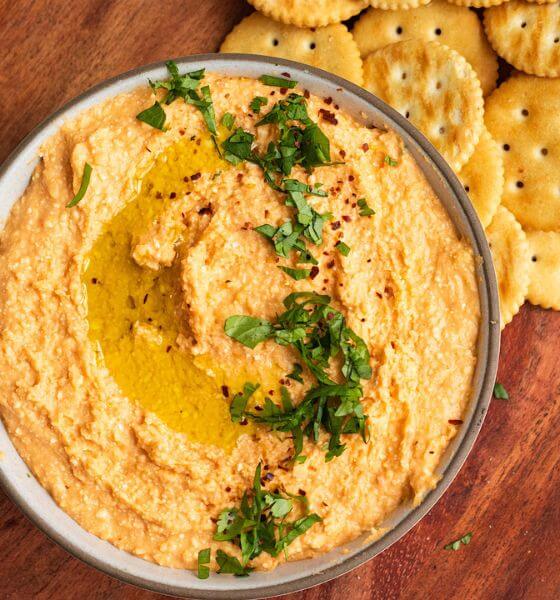White bean dip in white and grey bowl.