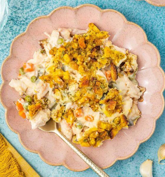 Chicken stuffing casserole on pink scalloped plate